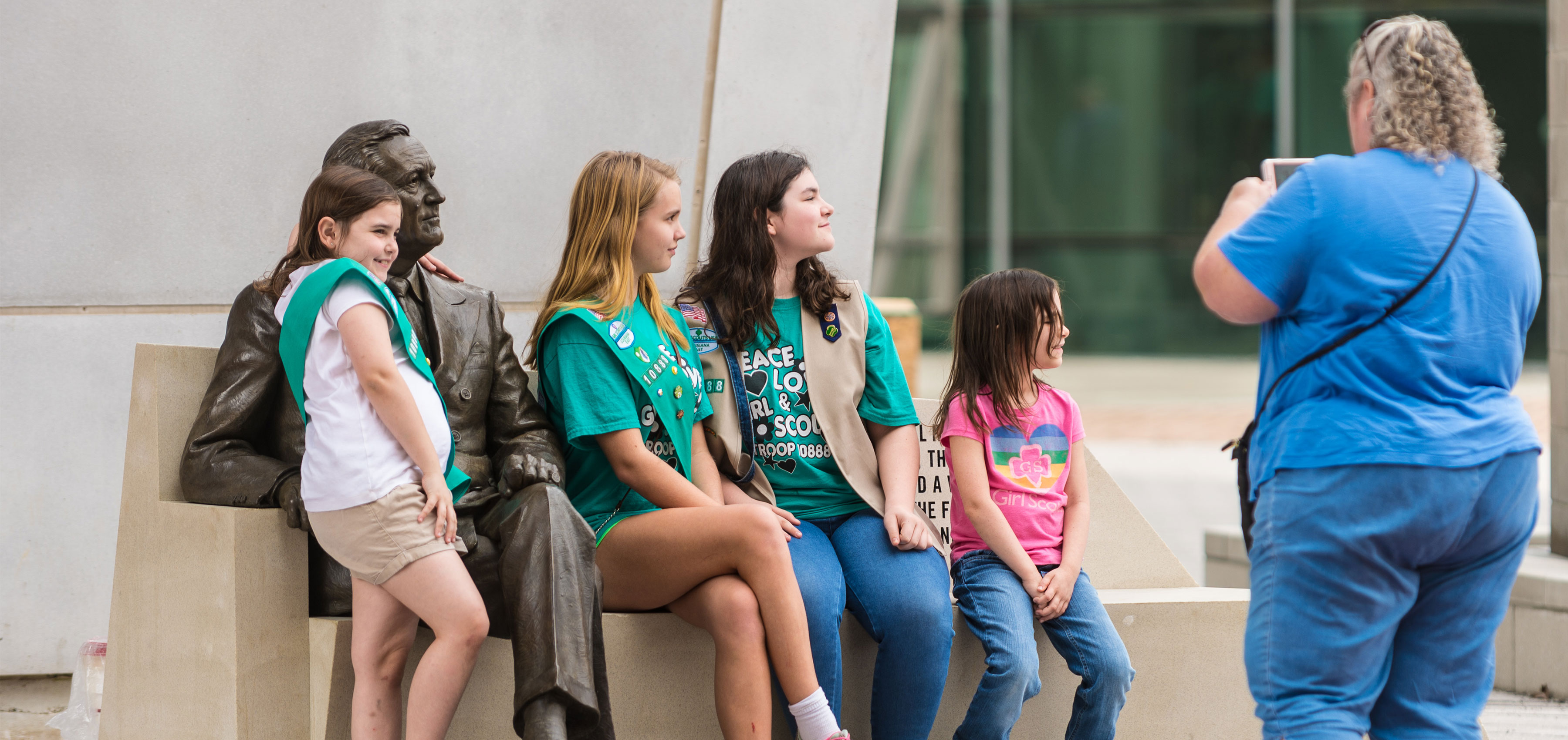 Kids and family posing with FDR statue at The National WWII Museum