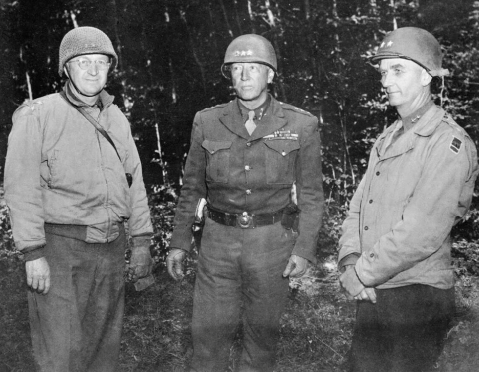 Lieutenant General George S Patton, Commanding General of the 3rd US Army, North-West Europe, conferring with Major-General Manton S. Eddy (left) and Major-General Horace MacBride. Courtesy Imperial War Museum