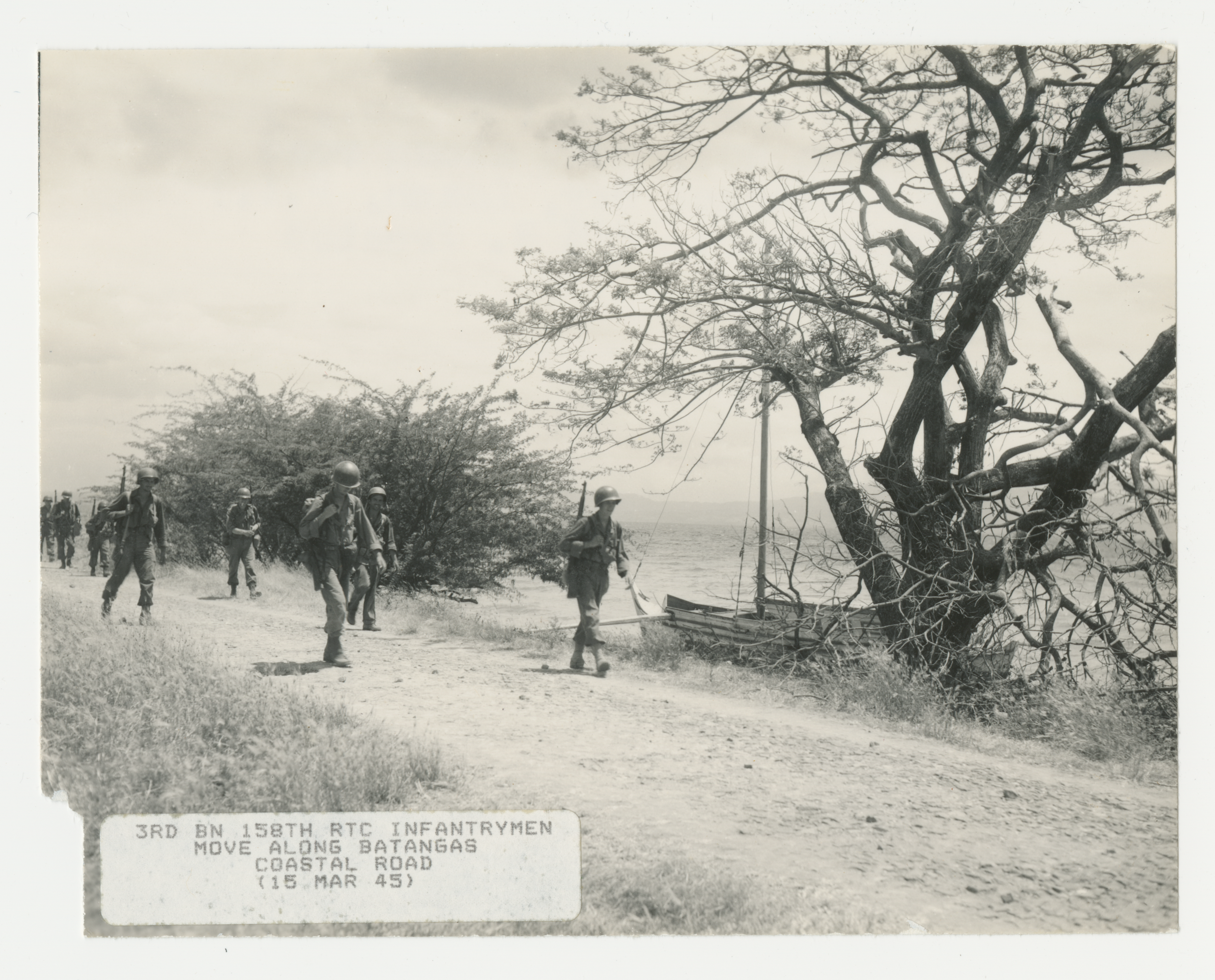3rd Bn 158th RCT infantrymen move along Batangas coastal road.