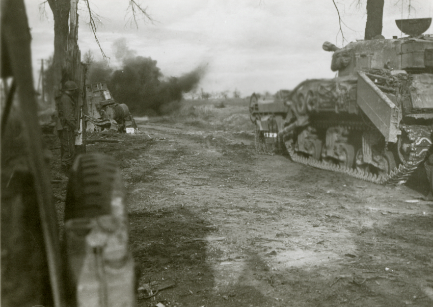 A Teller mine explodes as British Flail tanks conduct mine clearance on a road near Geilenkirchen