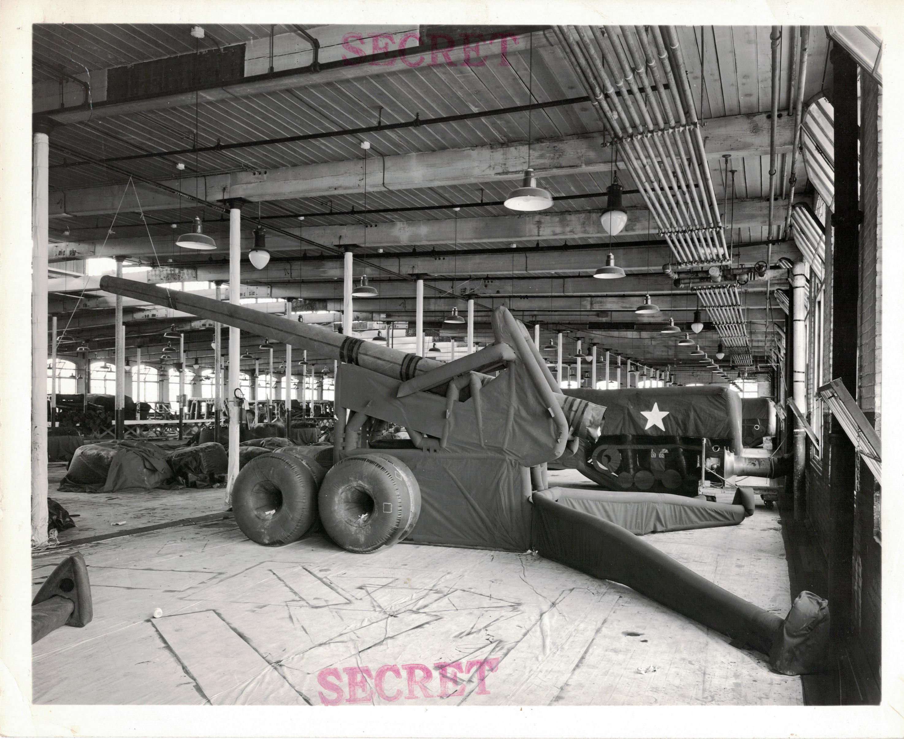 A recently manufactured dummy artillery piece on the factory floor. 