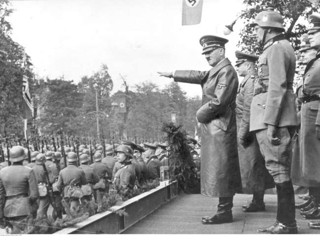 Adolf Hitler receives a parade of German troops in Warsaw