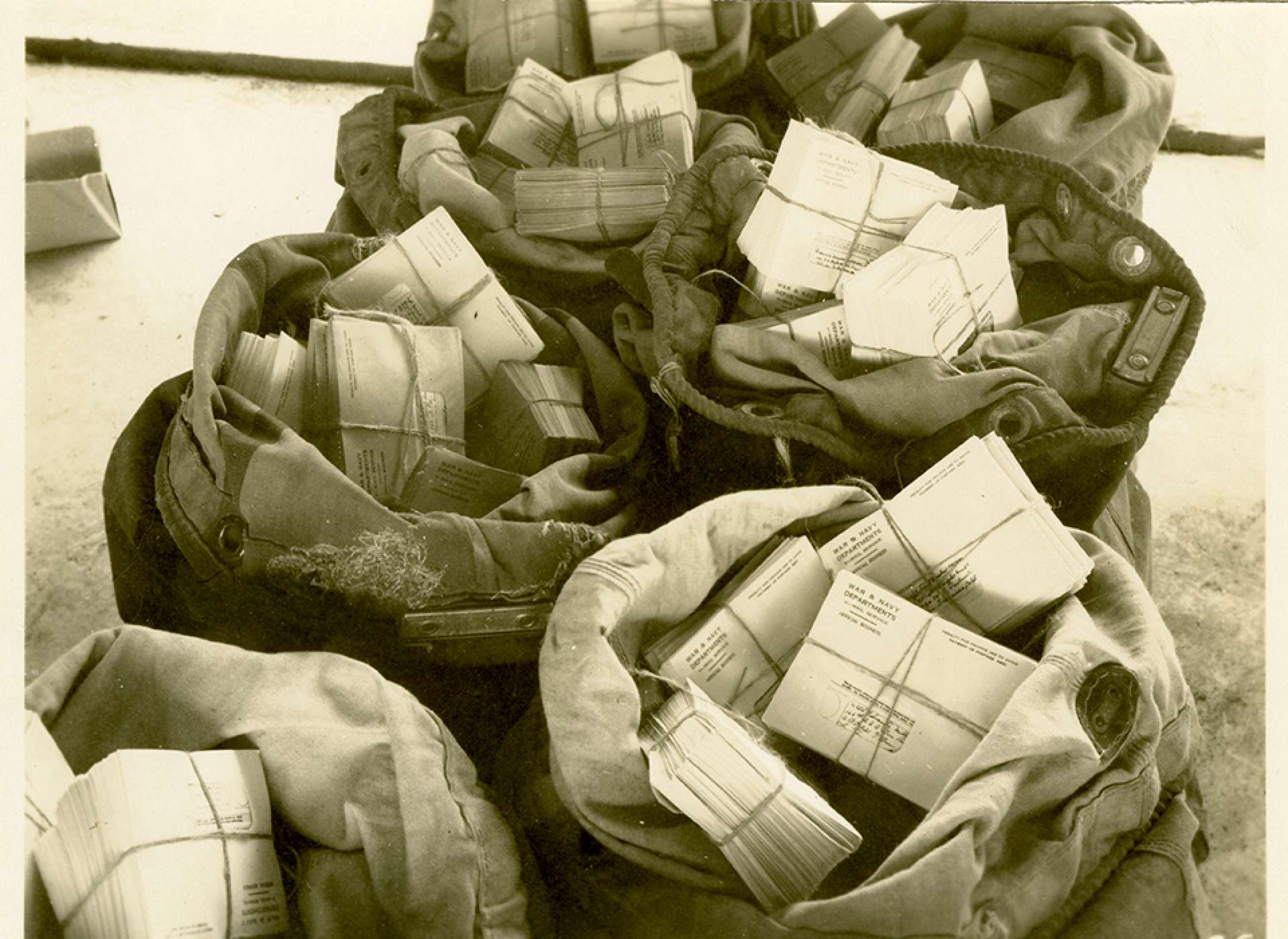 V-mail operation in the field at APO 929.”Finished V-Mail bundled, bagged and ready for dispatch through the APO to the troops.” Port Moresby, Papua New Guinea. 1944