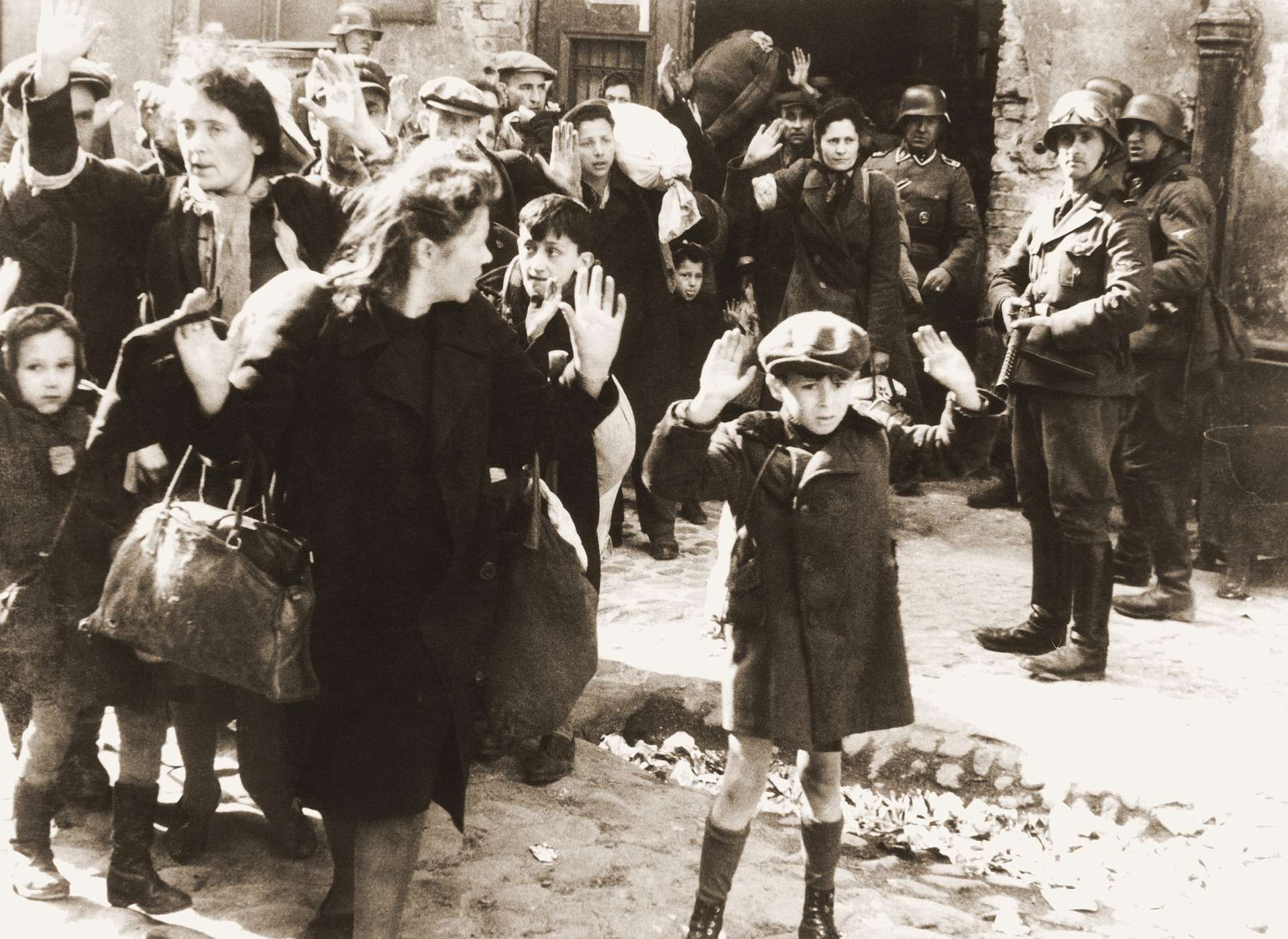 Nazi soldiers round up Jews for arrest during Warsaw Ghetto Uprising.