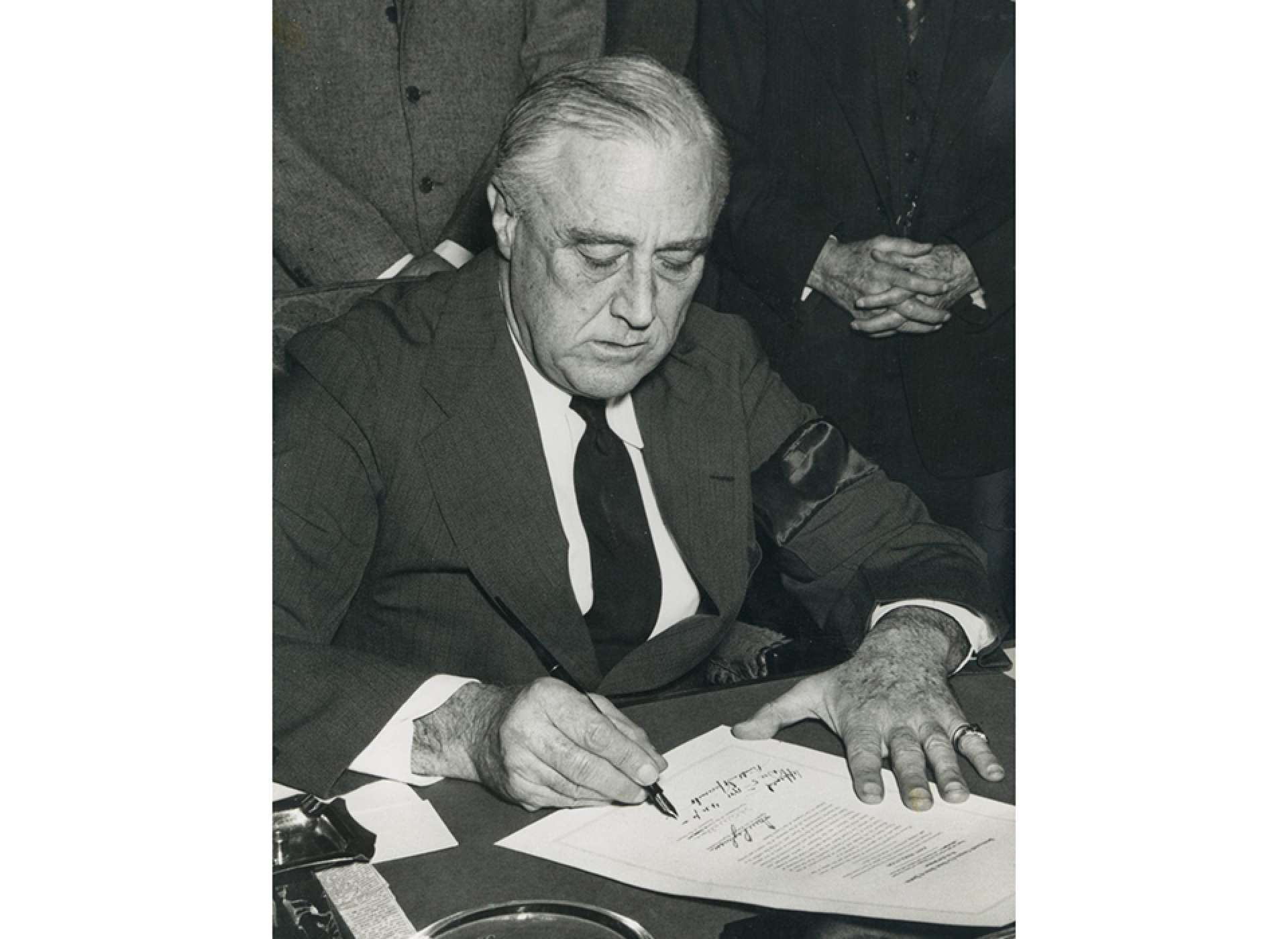 FDR signing the declaration of war against Japan on December 8, 1941. Courtesy of the National Archives.