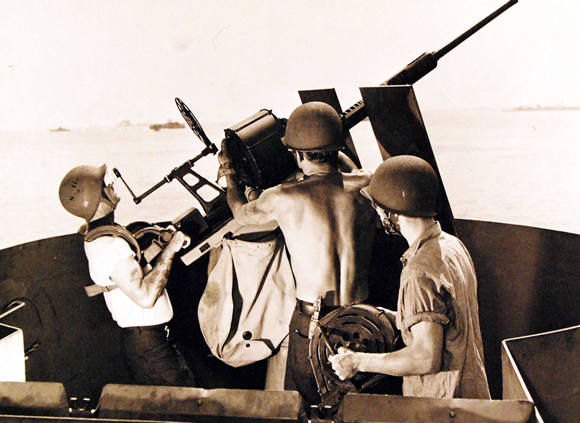 Merchant crew and Navy Armed Guard practice operating a 20mm gun