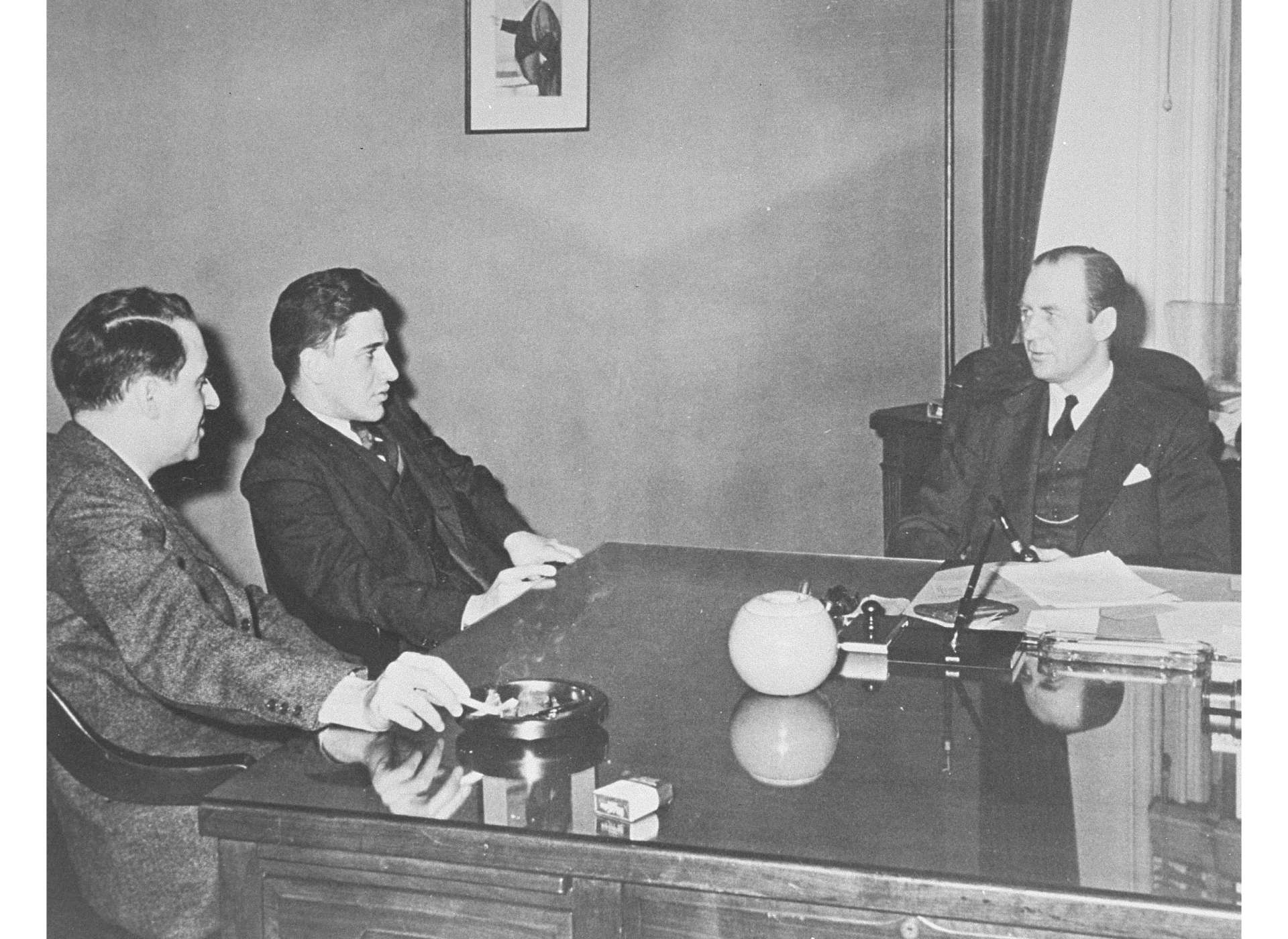 Members of the War Refugee Board staff (left to right, Albert Abrahamson, Josiah DuBois, and WRB director John Pehle) meet in Pehle’s office at the Treasury Department, March 1944. USHMM