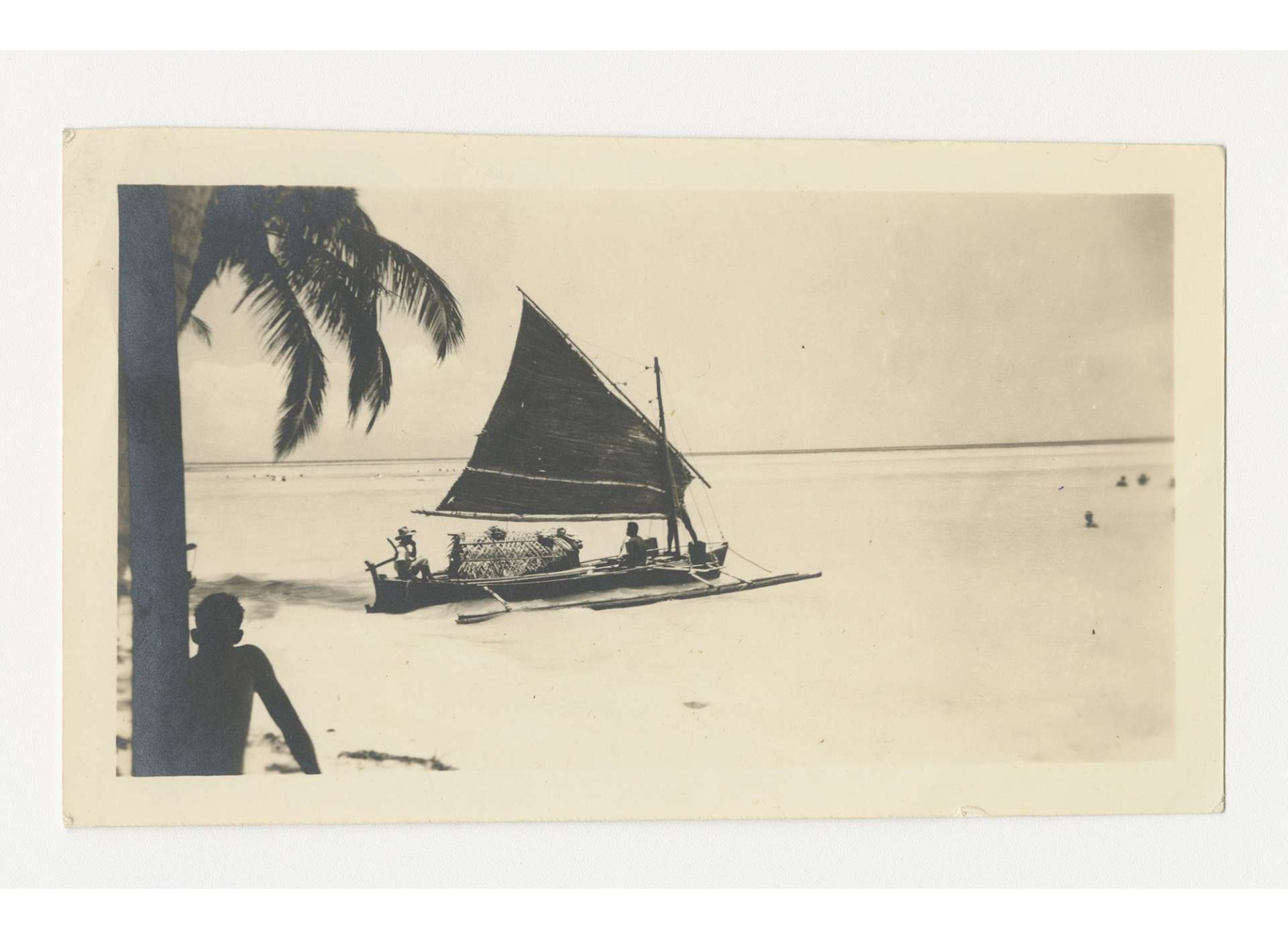 A wartime photo of a native outrigger canoe with a thatched-grass sail on Palawan. An outrigger similar to this helped guerrillas of the Palawan Special Battalion transport former-POWs about 25 miles south to the base at Brooke’s Point. Filipinos in an outrigger canoe with a thatched-grass sail on Palawan, 1945. Gift in Memory of John O. Spinks, Sr., from the Collection of The National World War II Museum, 2011.018.067.