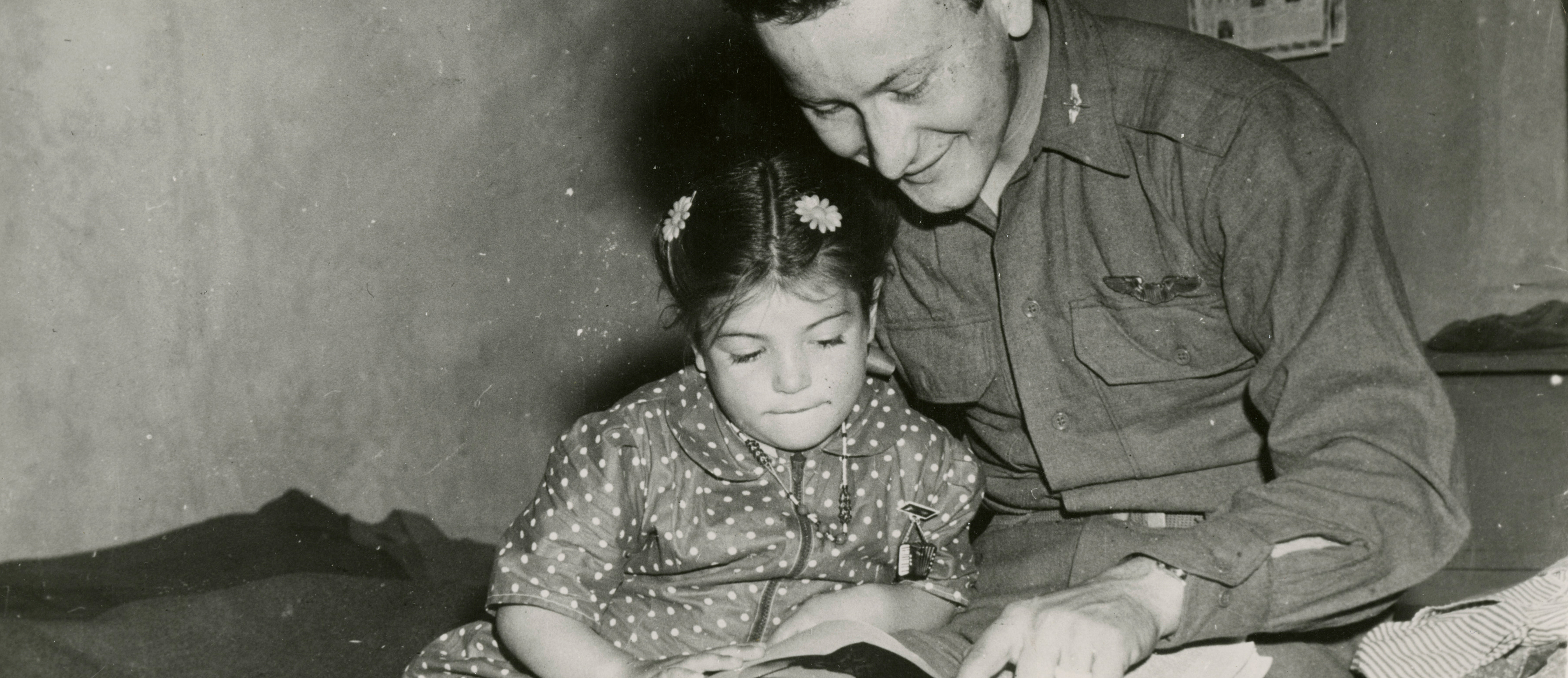 US Army soldier reads to girl 