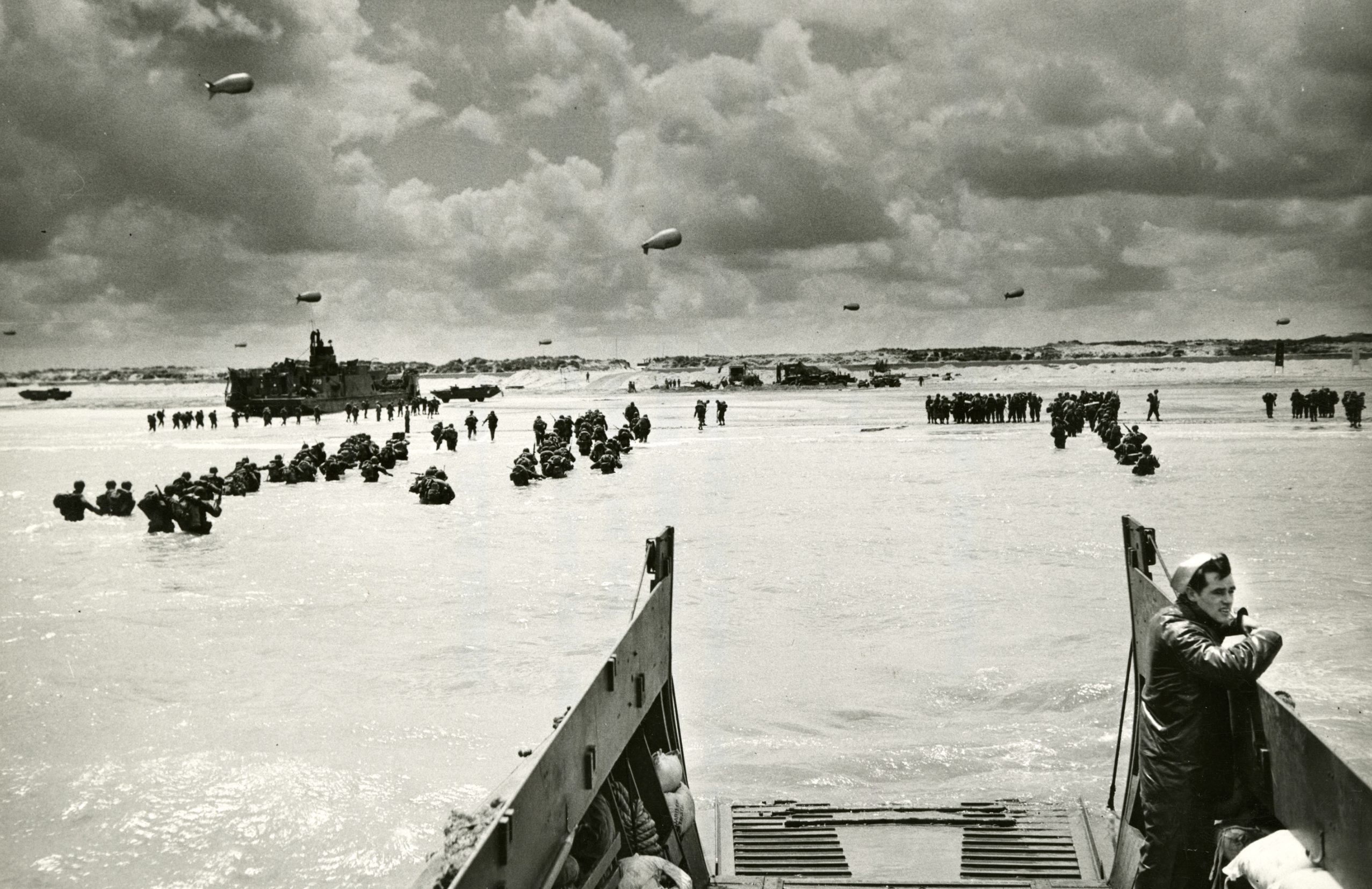 US Forces gathering on a Normandy Beach after D-Day, France 1944