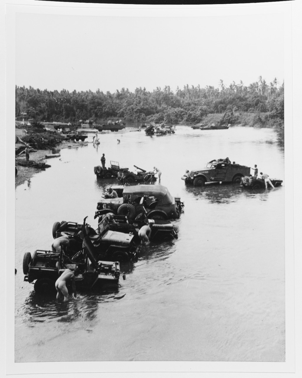 Soldiers and Marines washing themselves and their vehicles at Lunga River, Guadalcanal.