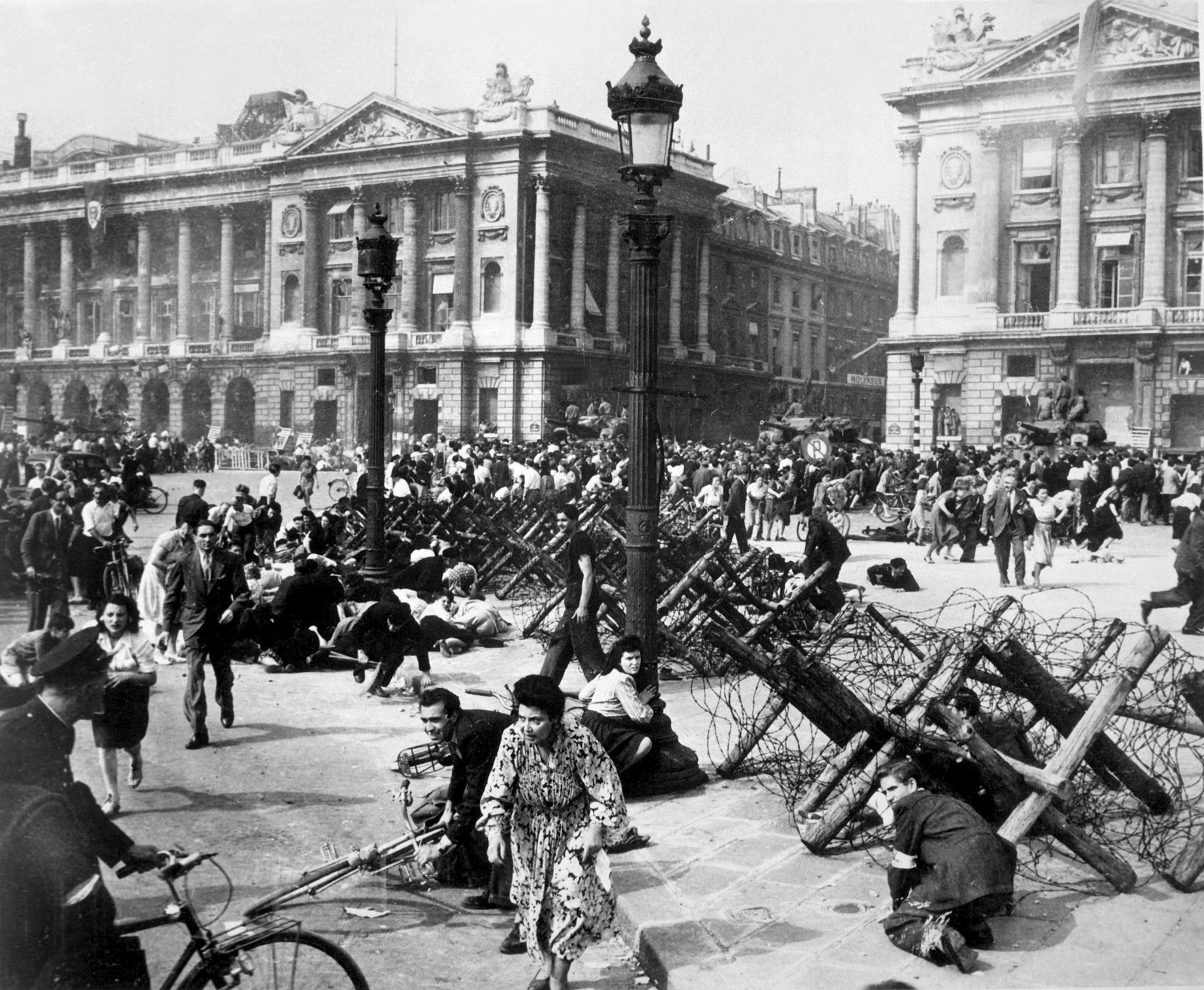 As allied troops enter Paris on 26 August, celebrating crowds on place De La Concorde scatter for cover from small bands of remaining German snipers