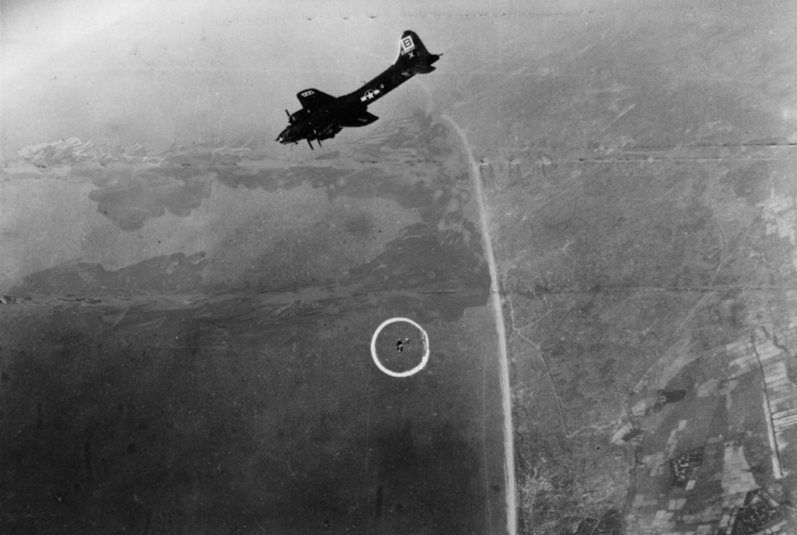 A damaged B-17 (circled) of the 95th Bomb Group falls from the formation