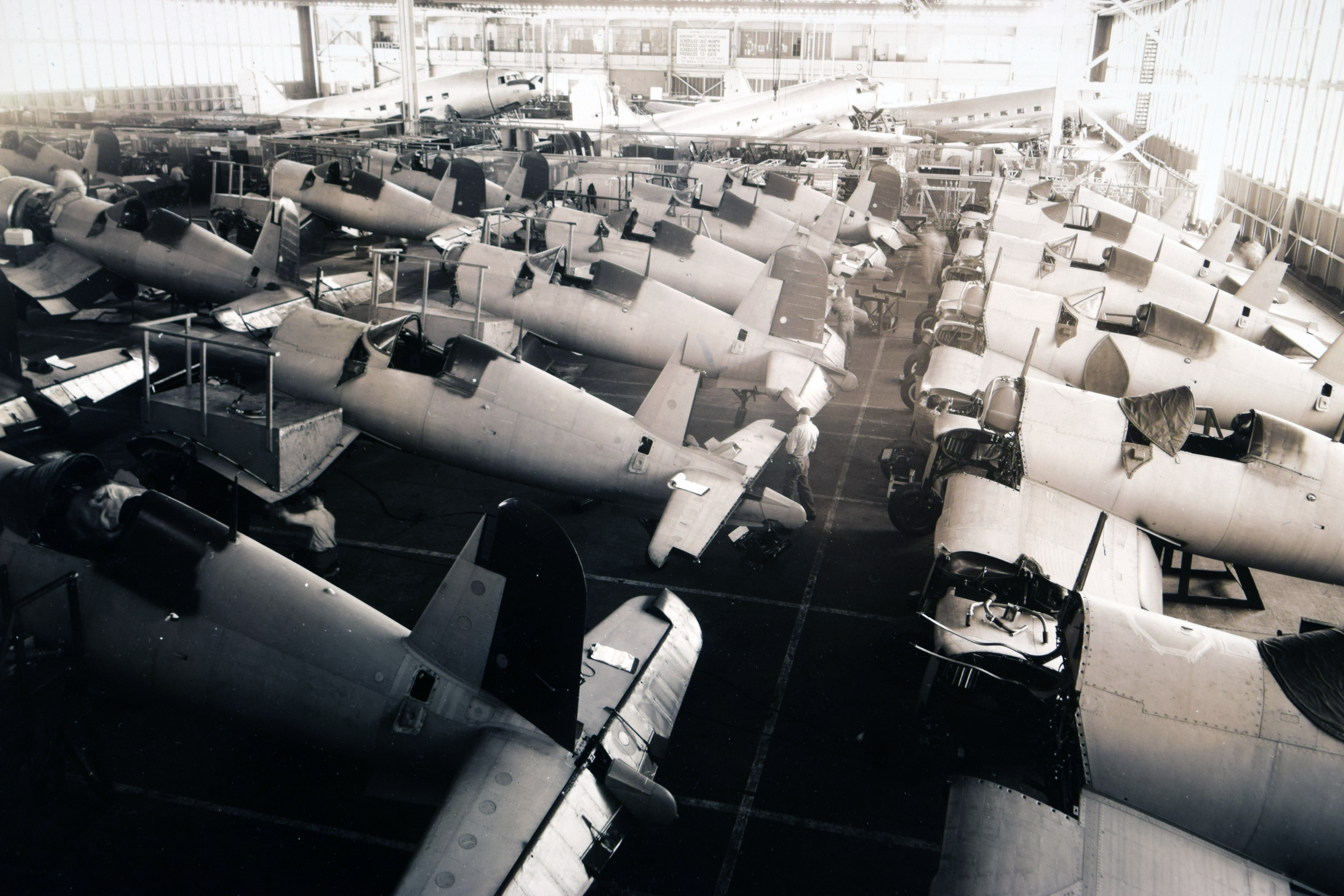 dozens of Chance Vought F4U Corsair Navy fighters undergo a heavy refit in 1950.