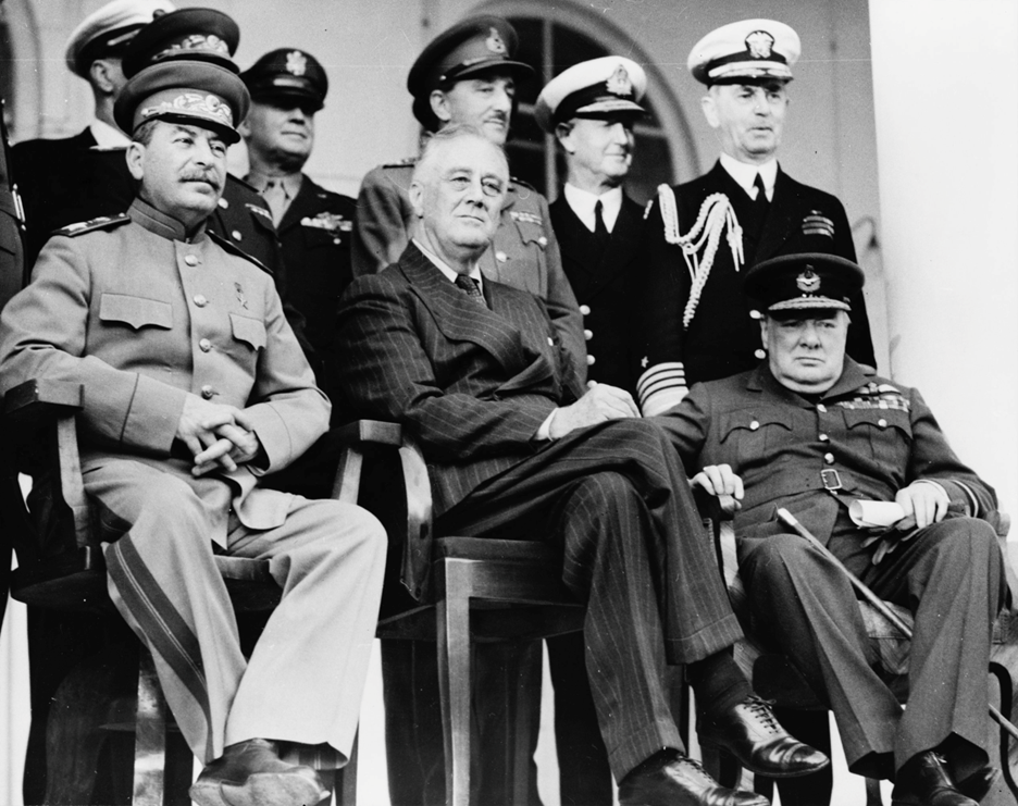 Front row: Stalin, Roosevelt, and Churchill on the portico of the Russian Embassy in Tehran. 