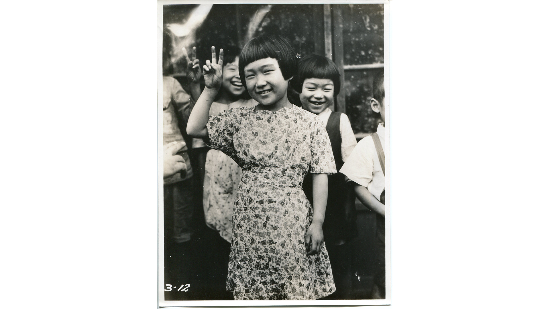 Young Japanese girl gives V for Victory sign