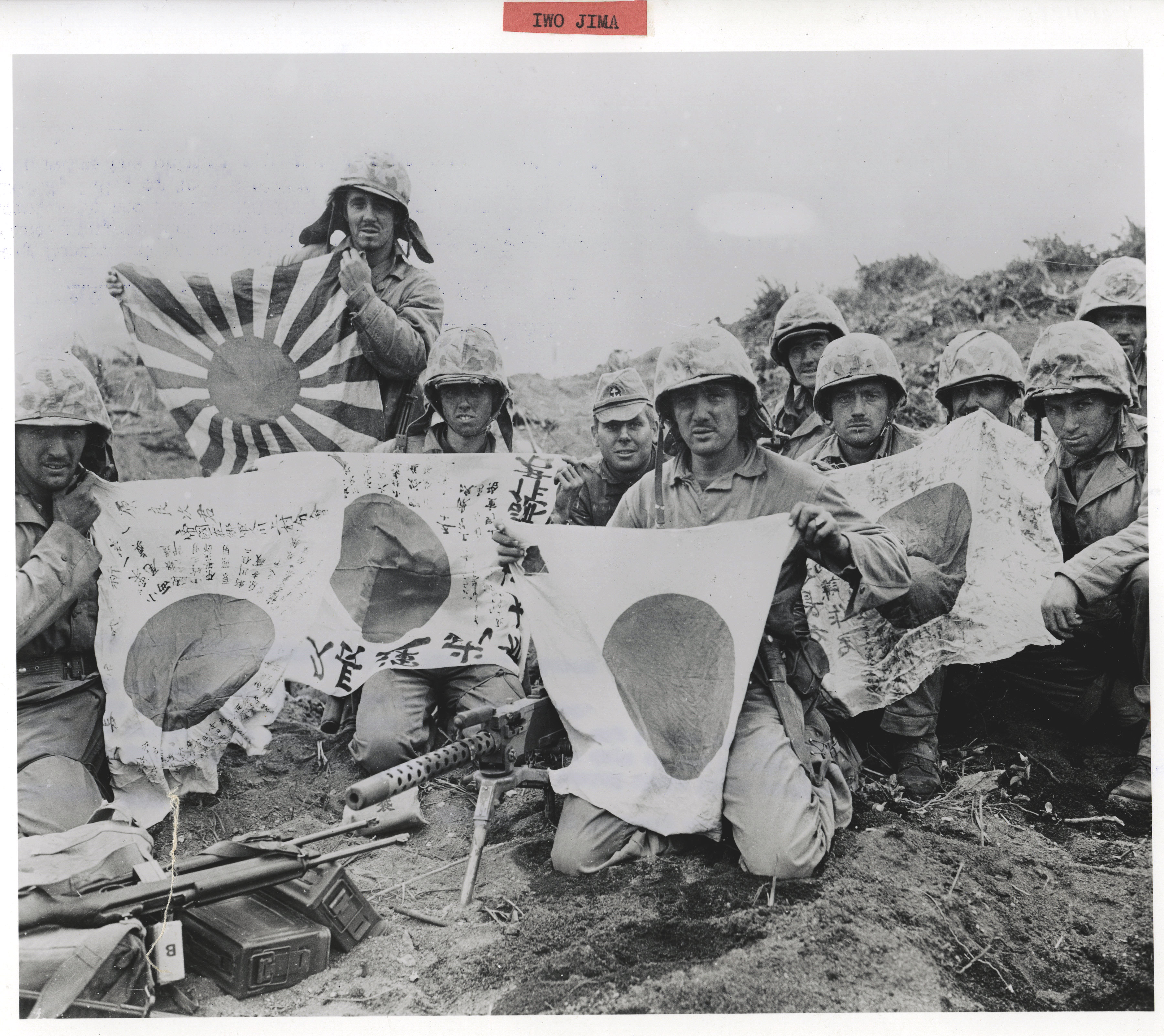 Fifth Marine Division Marines showing of their captured enemy battle flags