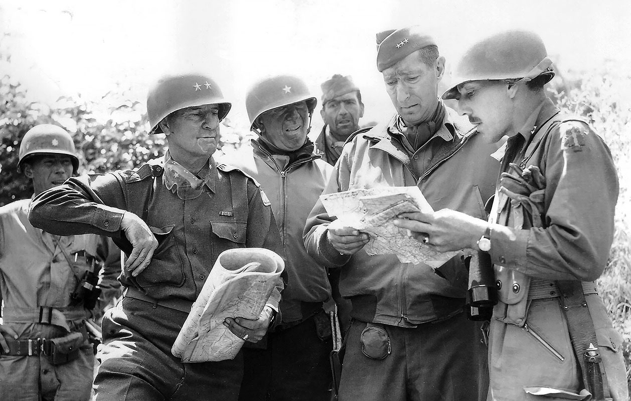 Mark Clark, and 1st Special Service Force commander Brigadier General Robert Frederick study a map on the outskirts of Rome on the morning of June 4, 1944.