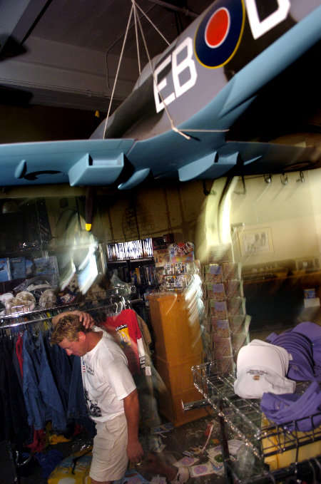 A Museum employee surveys the damage from Hurricane Katrina.