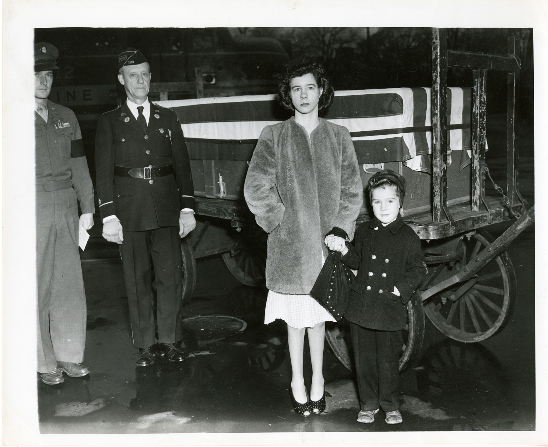 Lieutenant Colonel Carroll Grinnell and a United States Army officer standing beside a war widow