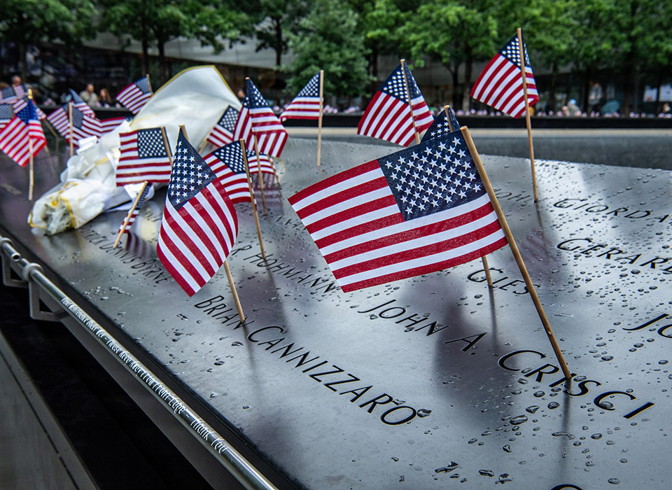American flags are placed to honor the victims of the 9/11 terrorist attack at the South Tower Pool near the 9/11 Memorial & Museum