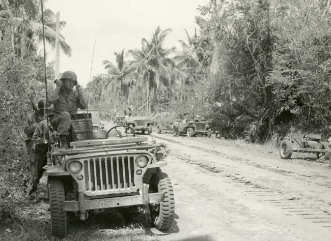 Soldier with radio in Jeep, Pacific theater