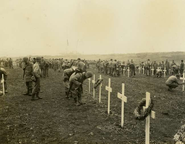 Soldiers viewing graves