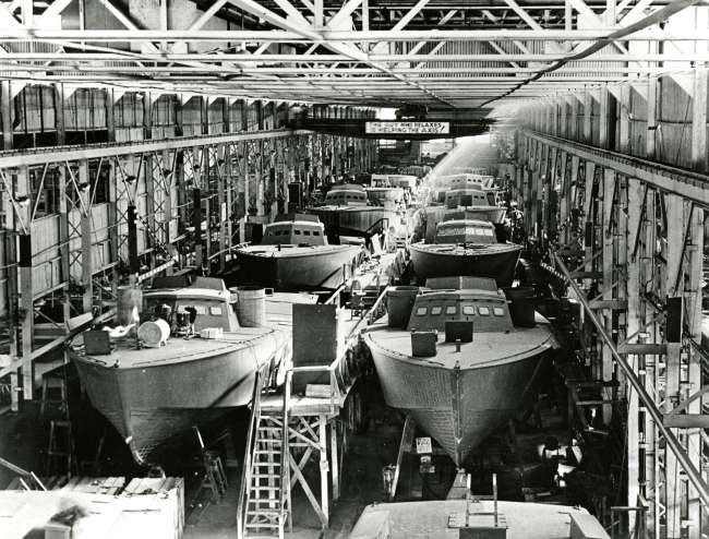 PT Boats lined up in factory in New Orleans during WWII