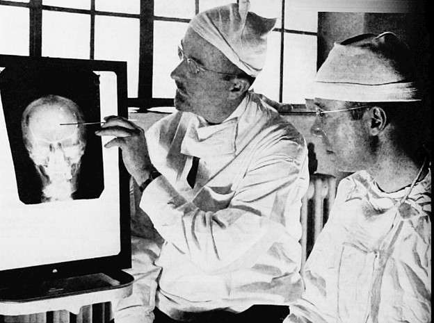 Walter Freeman and James Watts planning lobotomy in 1941, via Wikimedia Commons