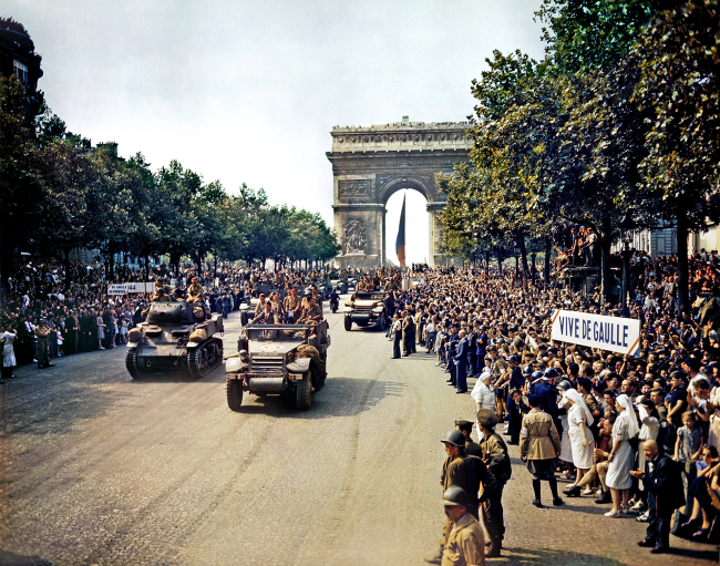 Crowds of French patriots line the Champs-Élysées to view Free French tanks and halftracks 