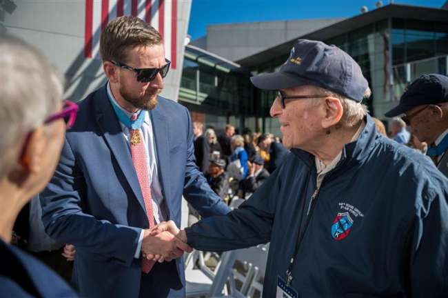 Medal of Honor Recipient Ryan Pitts shakes hands with WWII veteran Norman Bussel 
