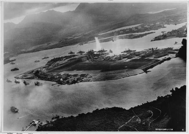 Photograph taken from a Japanese plane during the torpedo attack on ships moored on both sides of Ford Island.