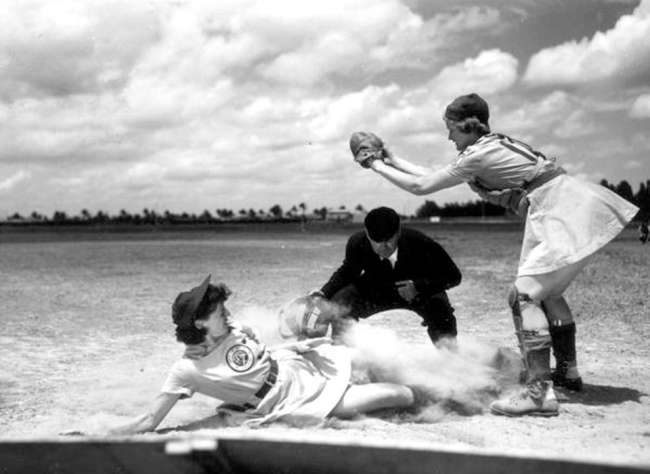 Vivian Kellogg, catcher with the Fort Wayne Daisies (AAGPBL) awaits a throw as second baseman Marg Callaggah slides safely into home