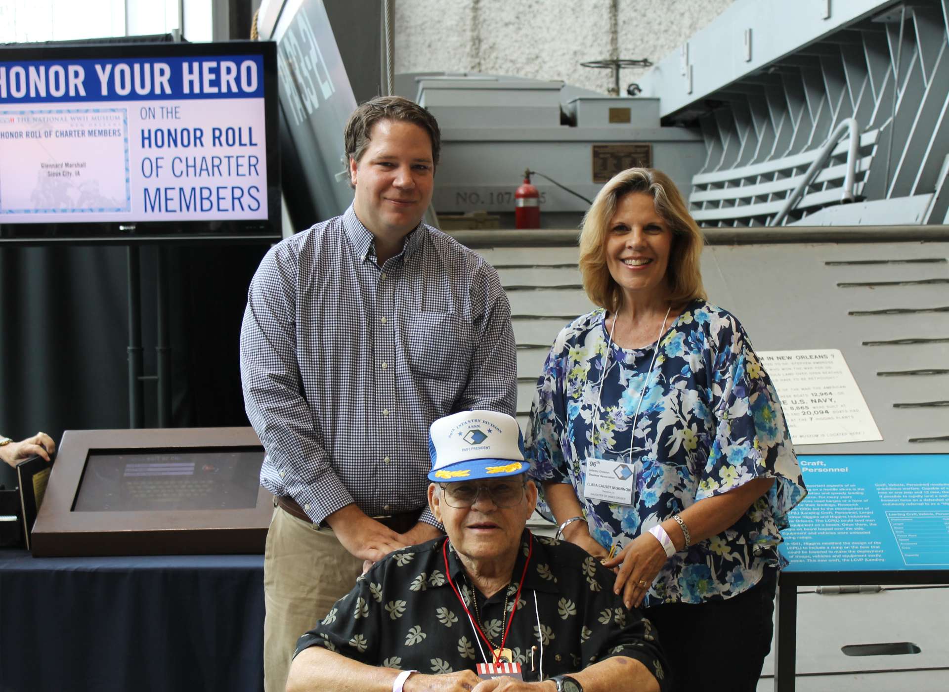 Patriots Circle members and Museum staff member in front of Higgins boat