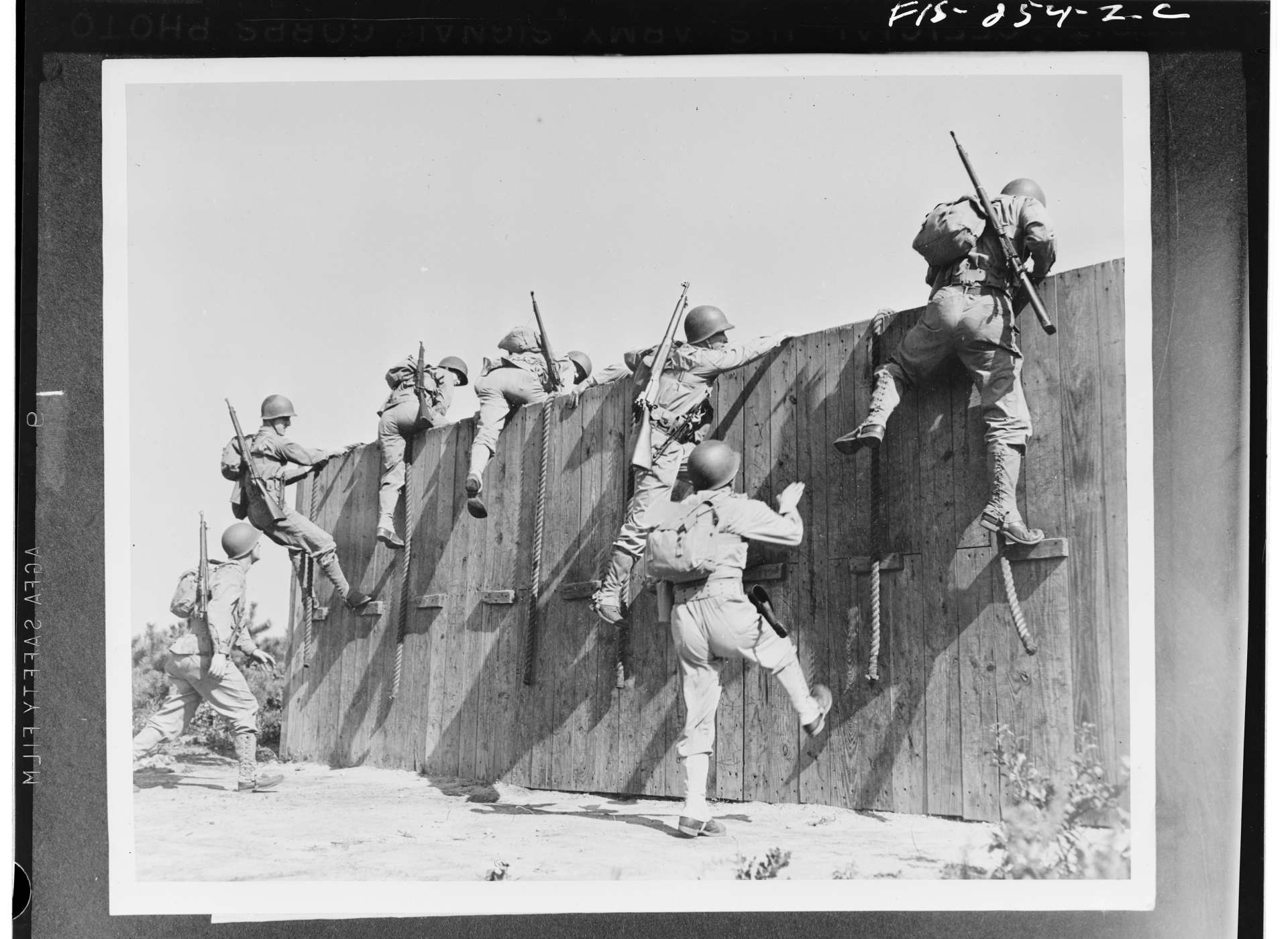 Soldiers tackle part of an obstacle course at Camp Edwards, Massachusetts, 1942.