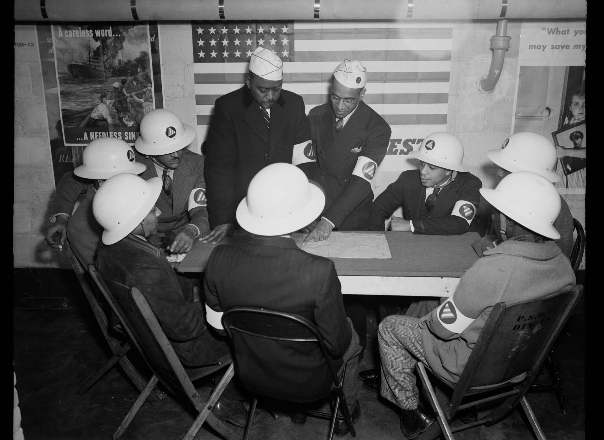 Air raid wardens meet to plan their response in the event of an attack (1943).