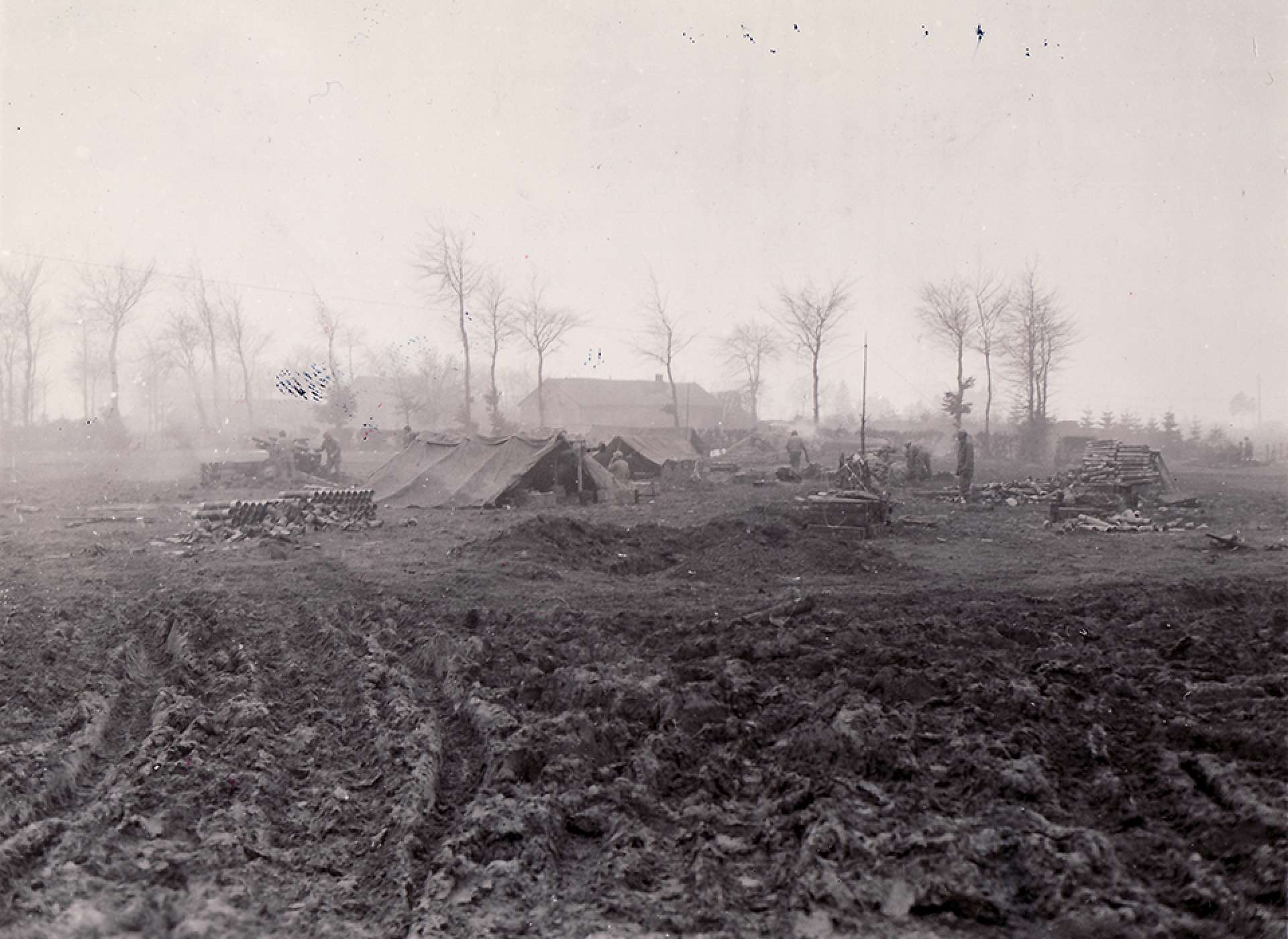 2nd Division howitzers firing toward German lines at Elsenborn (38th FA Btln). The National WWII Museum Digital Collections.