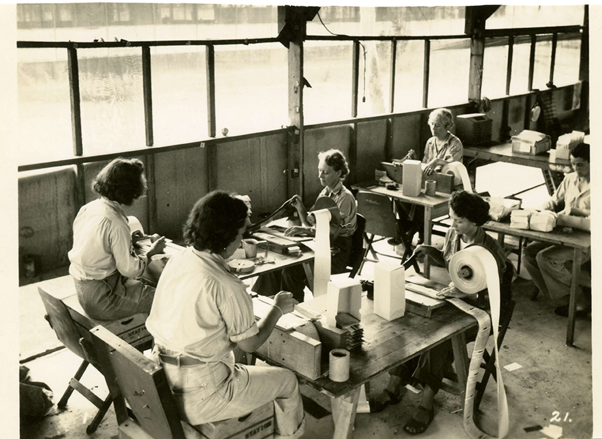 V-mail operation in the field at APO 929. “Paper chopping. At these choppers each letter is handcut from the roll and here the culls or bad letters are pulled out. Approximately twenty minutes is required to completely chop a full roll of V-Mail.&quot; Port Moresby, Papua New Guinea. 1944