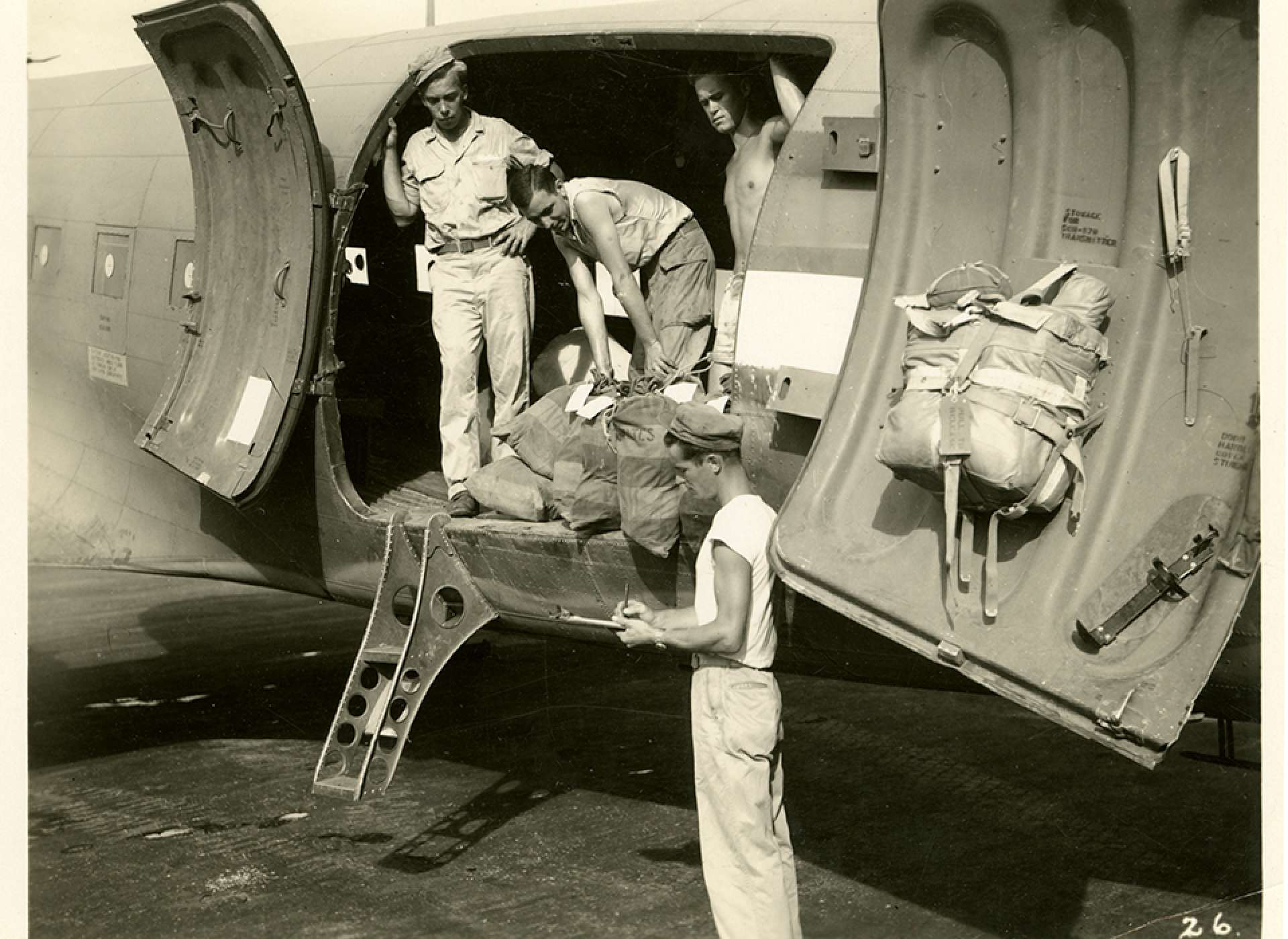 V-mail operation in the field at APO 929.&quot;The final act at the airstrip with the mail truck, containing letters for the States and for the troops, pulled alongside the plane.&quot; Port Moresby, Papua New Guinea. 1944