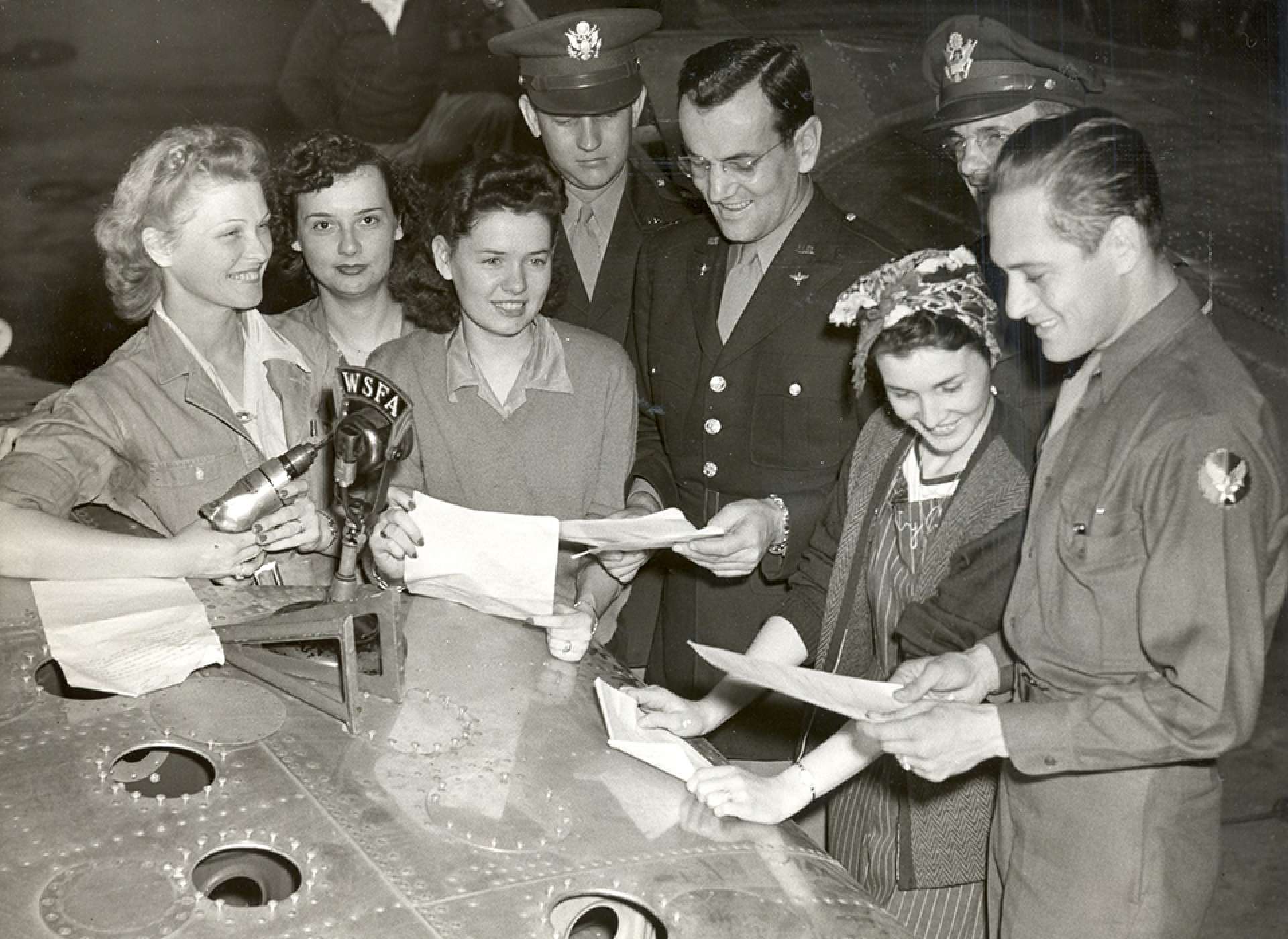 Miller (center) at the recording of one of the more than 500 radio broadcasts he and the Army Air Forces Band created. US Air Force photograph.