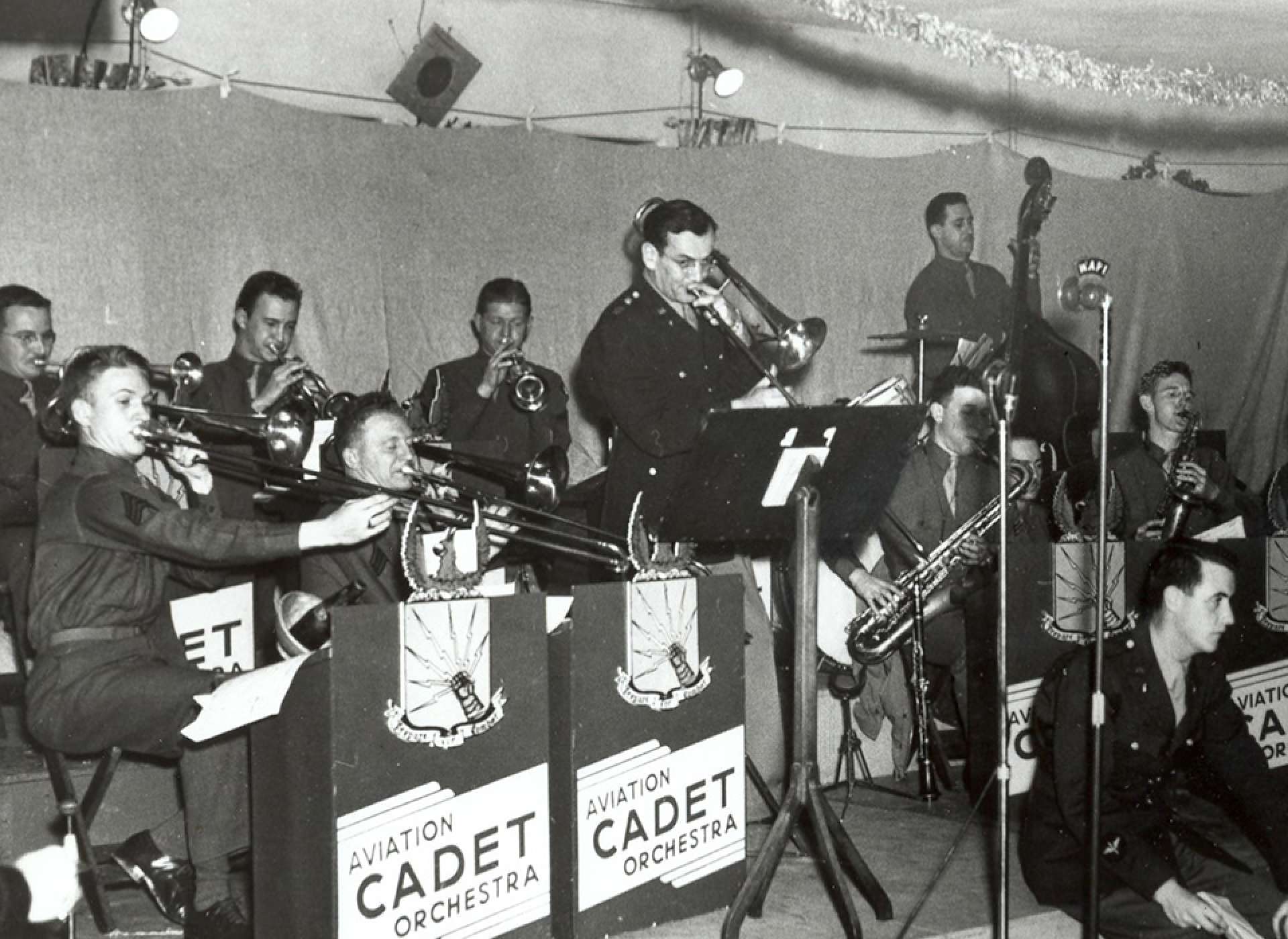 Miller (standing, center) plays the trombone with one of his early USAAF bands at Christmas, 1942. US Air Force photograph.