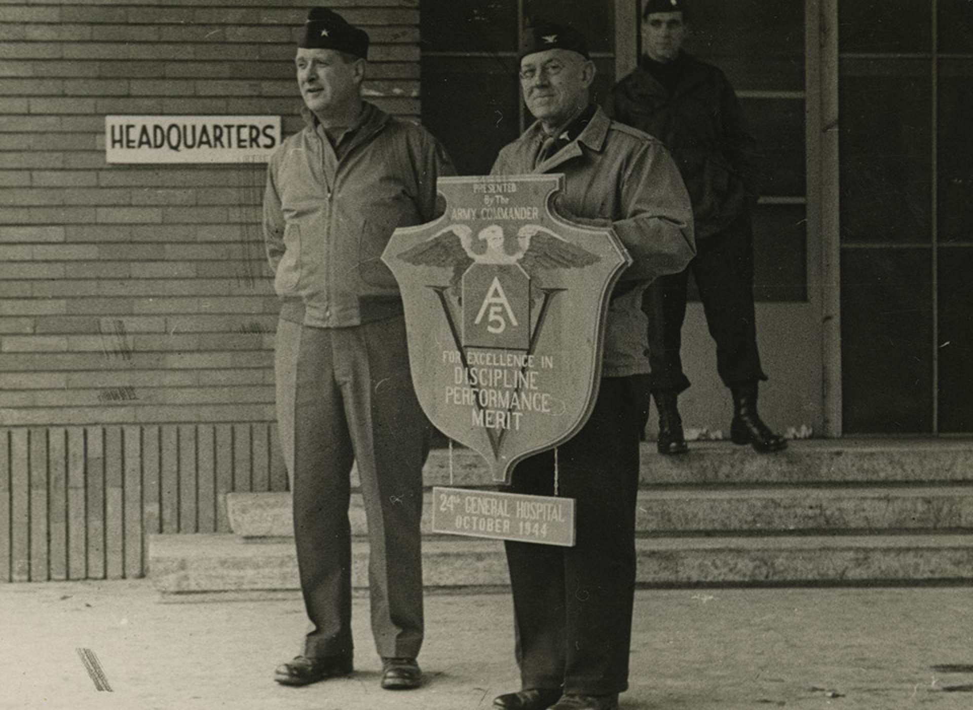 Colonel Walter Clifton Royals, Commanding Officer of the 24th General Hospital and Tulane doctor holds a plaque awarded to the Tulane Unit for their distinguished service to the 5th Army in Italy. The National WWII Museum.
