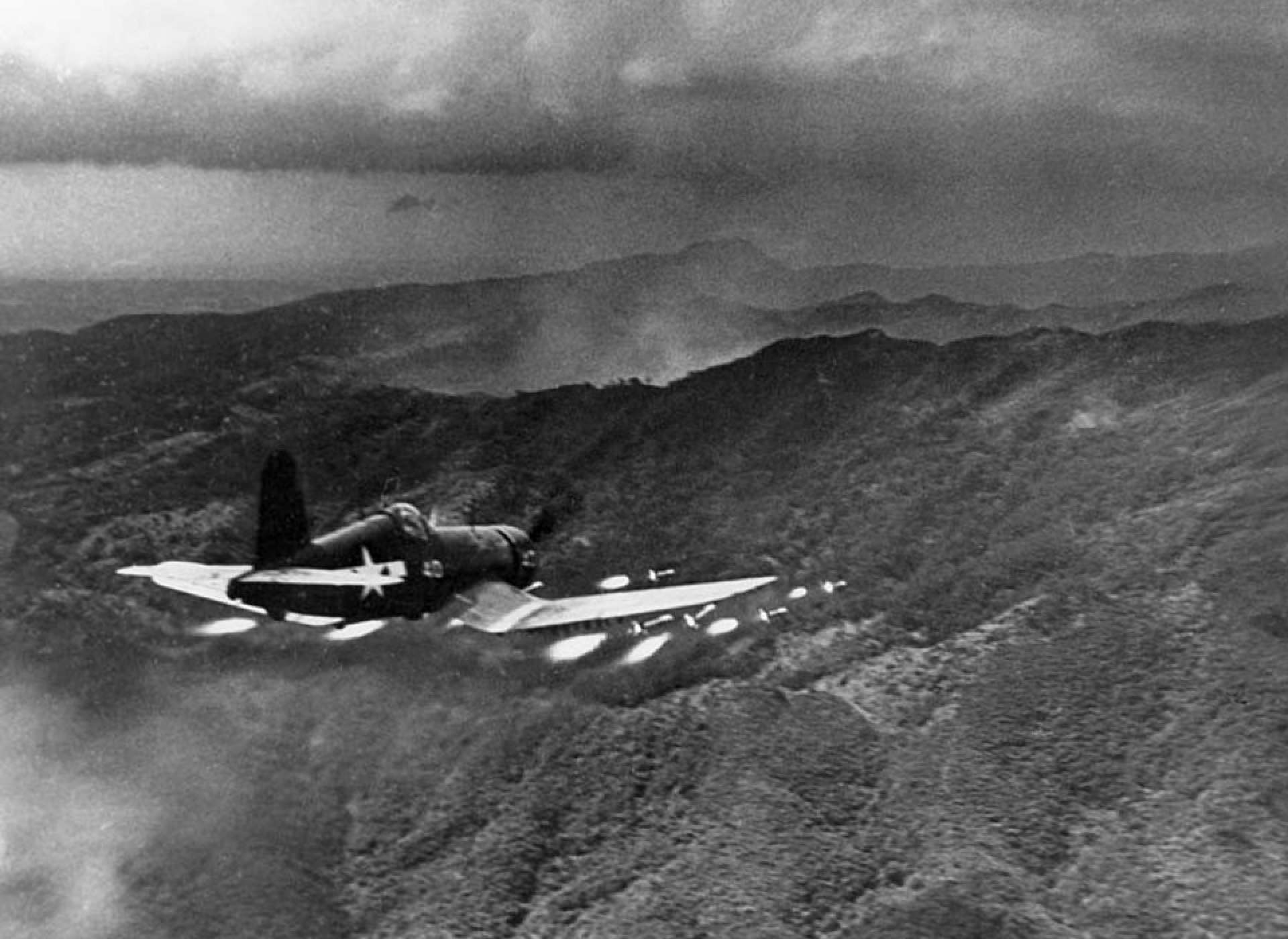 US Marine Corsair firing a full load of rockets at Japanese positions on Okinawa. Courtesy Naval History and Heritage Command.