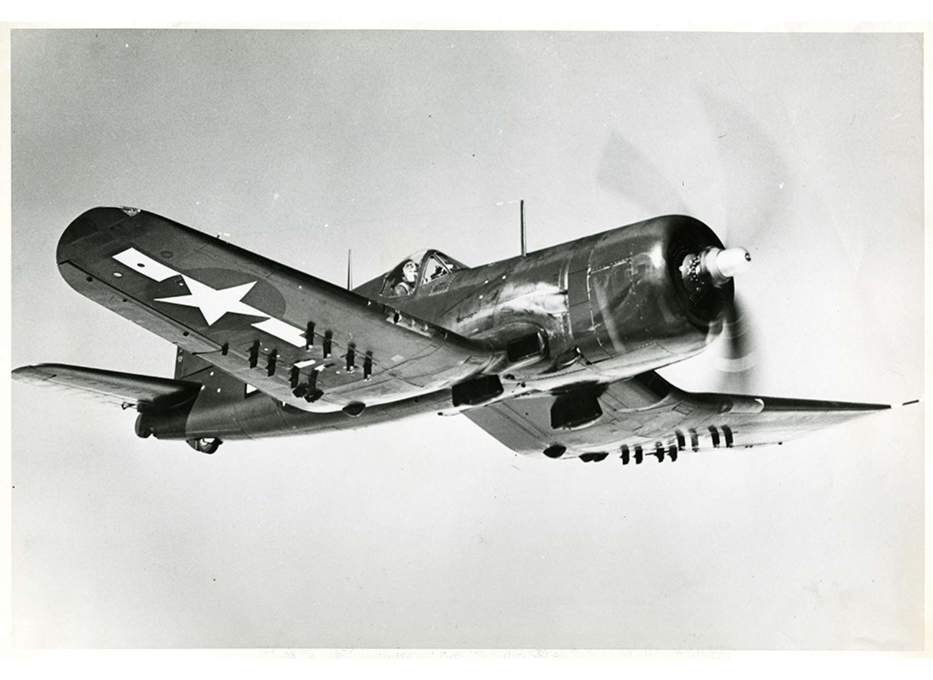 A F4U-4 Corsair in flight over the United States in July 1945. Gift In Memory of Isaac &quot;Ike&quot; Bethel Utley, 2012.019.692
