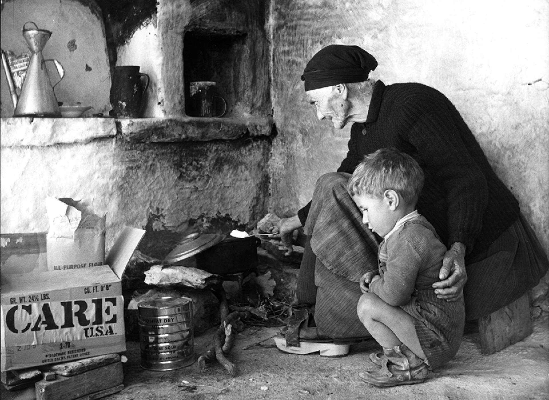 grandmother cooks a meal for herself and her orphaned grandson