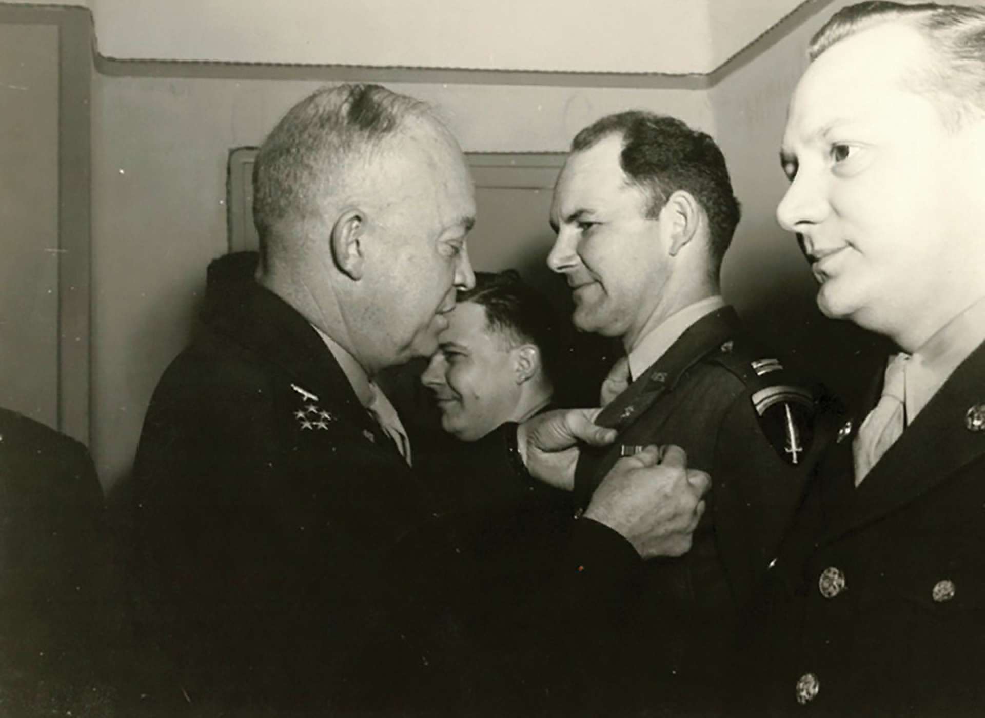 General Dwight D. Eisenhower pins a Bronze Star medal on the jacket of then-captain David Watson