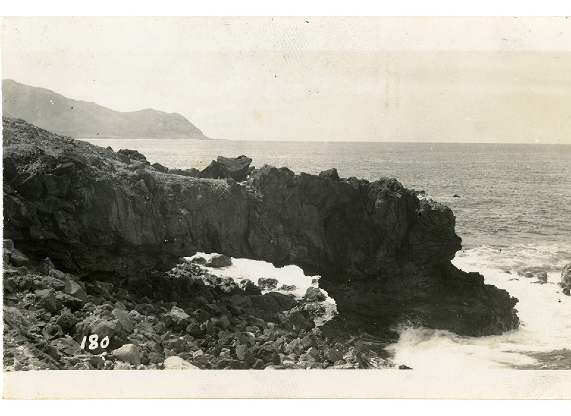 A natural arch formed on the rocky coastline, November 1945
