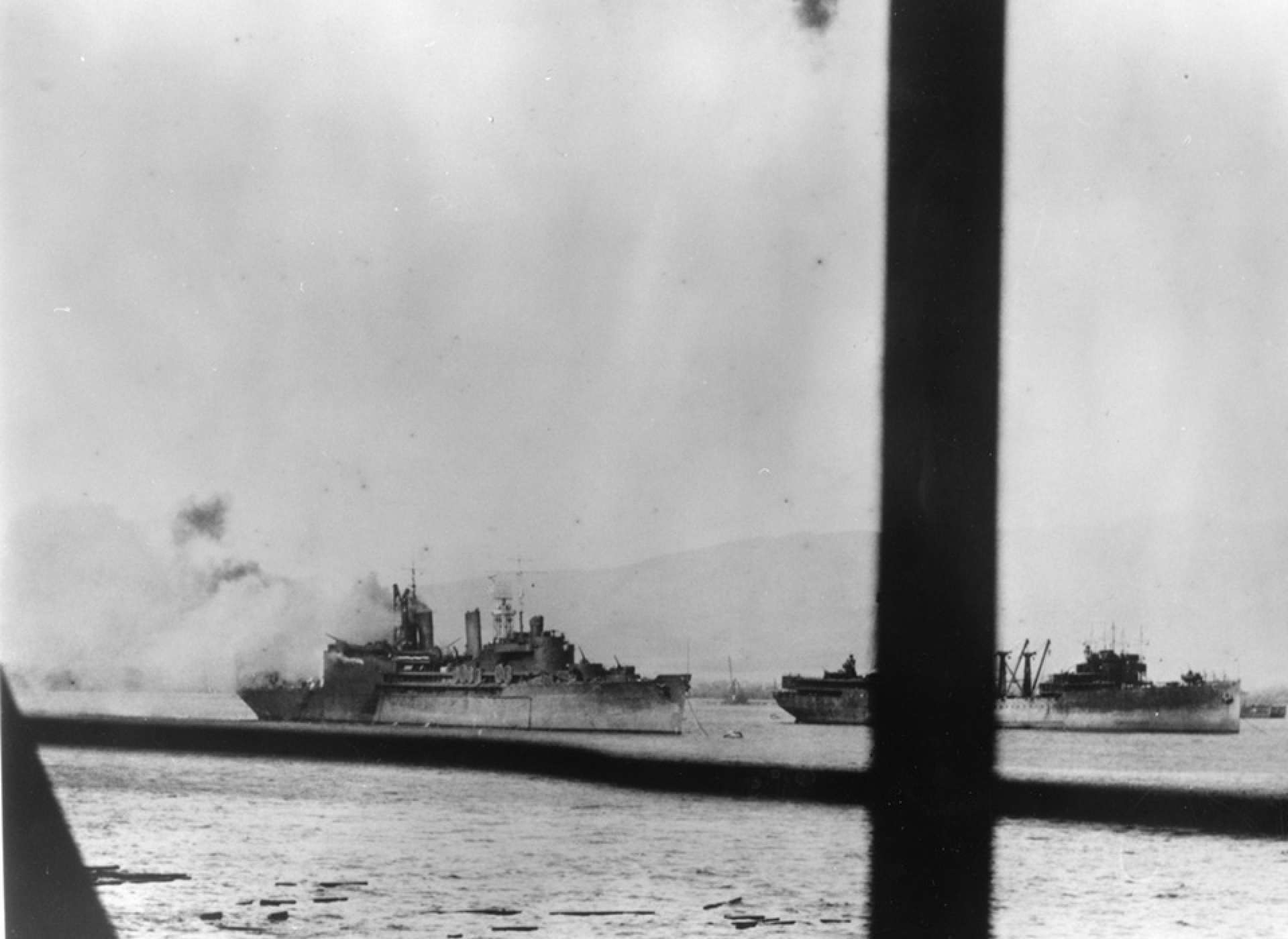 USS Curtiss (AV-4) is seen burning from a bomb hit at anchor in Pearl Harbor on December 7, 1941