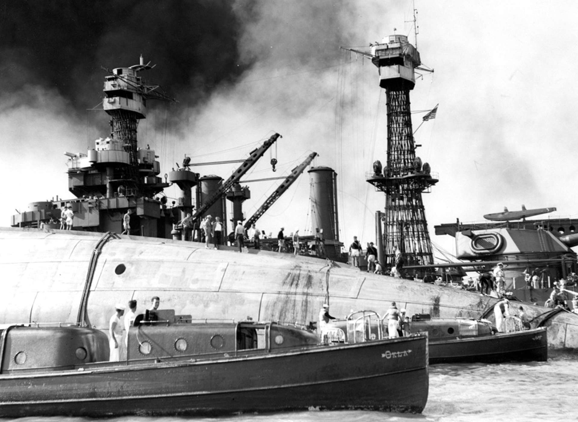 Rescue efforts underway on the overturned hull of USS Oklahoma (BB-37)