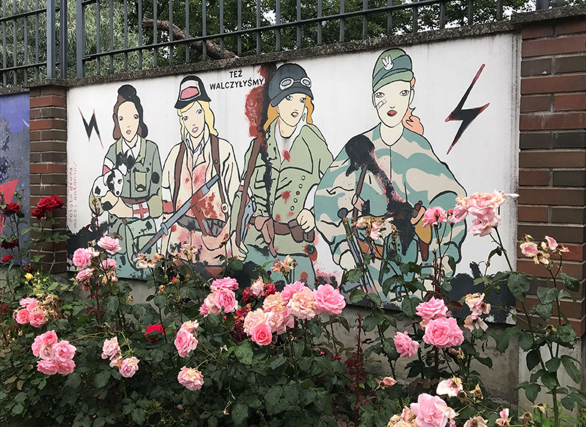 Painting in the courtyard behind The Warsaw Uprising Museum entitled “We also fought.”